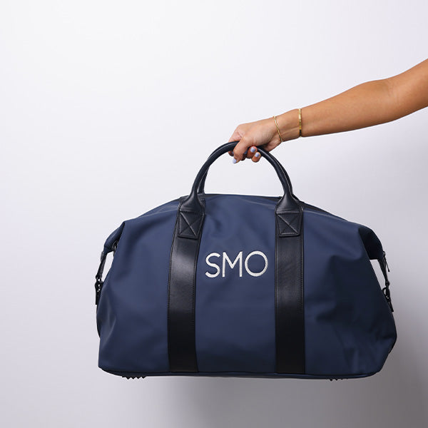 MEDIUM NAVY- DUFFLE BAG - BLACK HANDLE 69x26.5x29cm - 69x26.5x29cm حقيبة كتف متوسطة الحجم كحلي - مقبض أسود